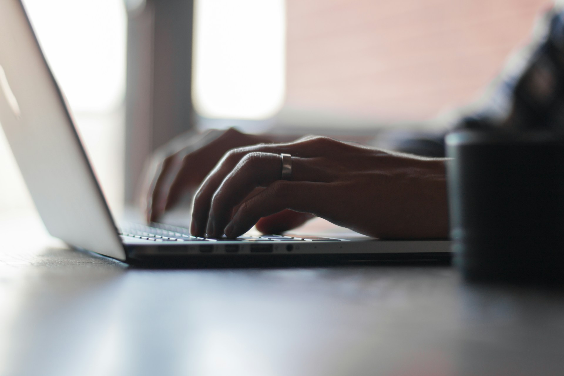 person working on a laptop, focusing on achieving productivity goals