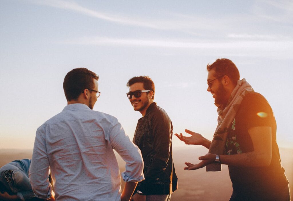 Three men laughing and interacting with each other