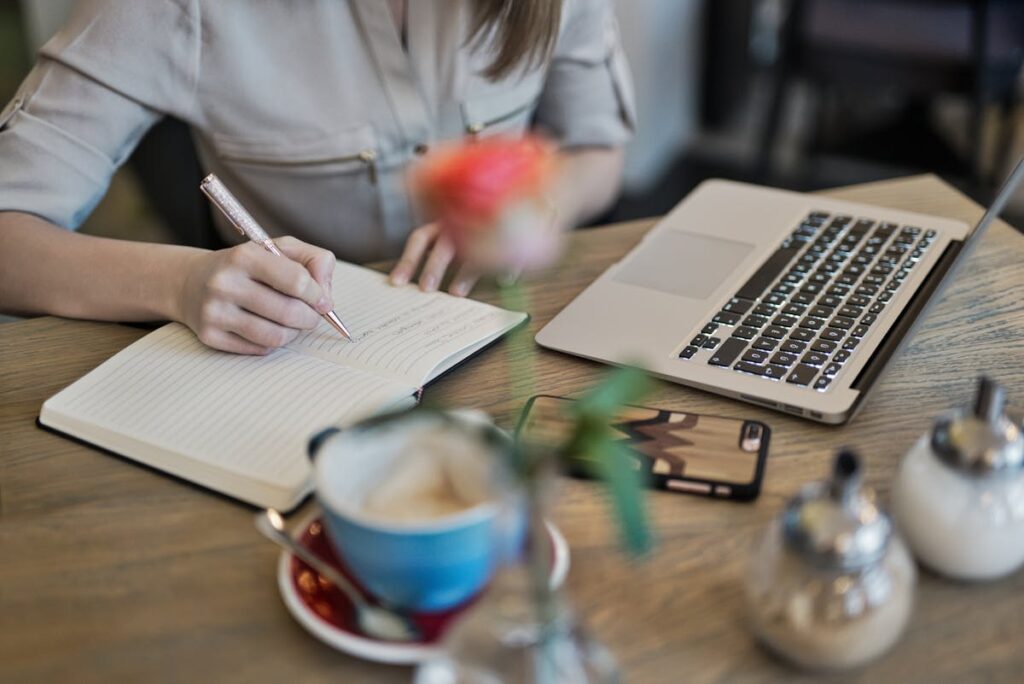 A woman writing notes and preparing for the upcoming meeting in order to ensure she feels confident and prepared