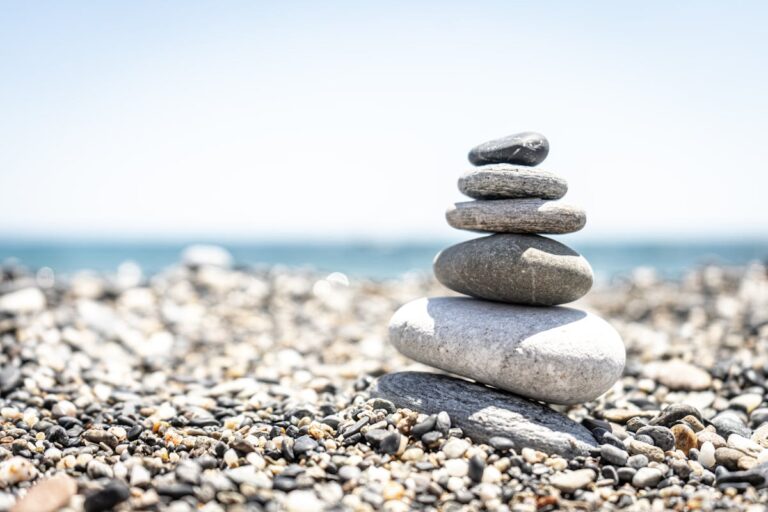 Stones standing on each other form a pyramid that symbolizes discipline and consistency